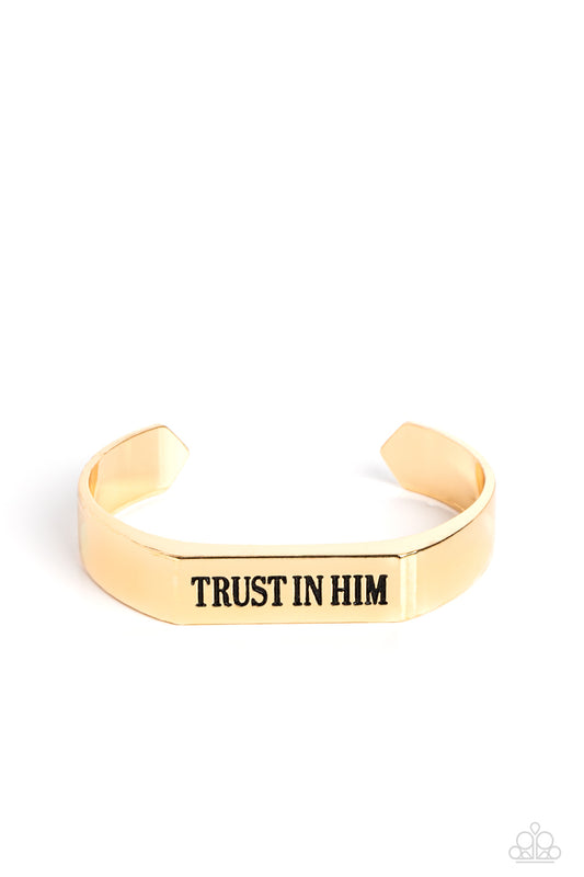 Paparazzi Accessories Trusting Trinket - Gold A thick, gold cuff coalesces into an edgy, urban statement across the wrist. Stamped on the center-most rectangular plate, the phrase "Trust in Him" boldly stands out for an inspirational finish. Sold as one i