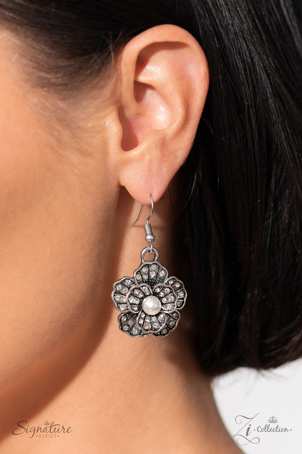 Paparazzi Accessories The Raven Polished white pearls and brilliant white rhinestones bloom atop a framework of silver, forming seven unique flowers adorned in dizzying detail. Each flower features a unique centerpiece encircled by silver petals lined wit