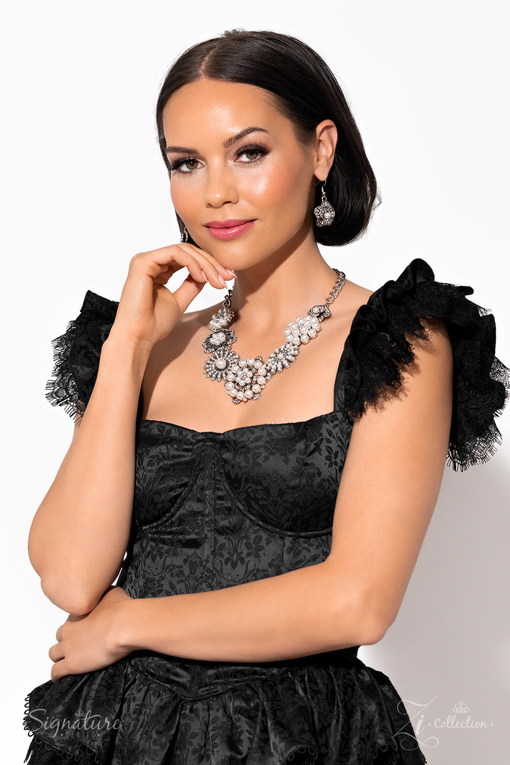 Paparazzi Accessories The Raven Polished white pearls and brilliant white rhinestones bloom atop a framework of silver, forming seven unique flowers adorned in dizzying detail. Each flower features a unique centerpiece encircled by silver petals lined wit