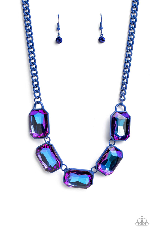 Paparazzi Accessories Emerald City Couture - Blue Featuring a vivacious blue chain, a collection of purple UV shimmery emerald-cut gems, pressed in vibrant blue frames, coalesces around the collar to create a playful pop of edgy color. Features an adjusta