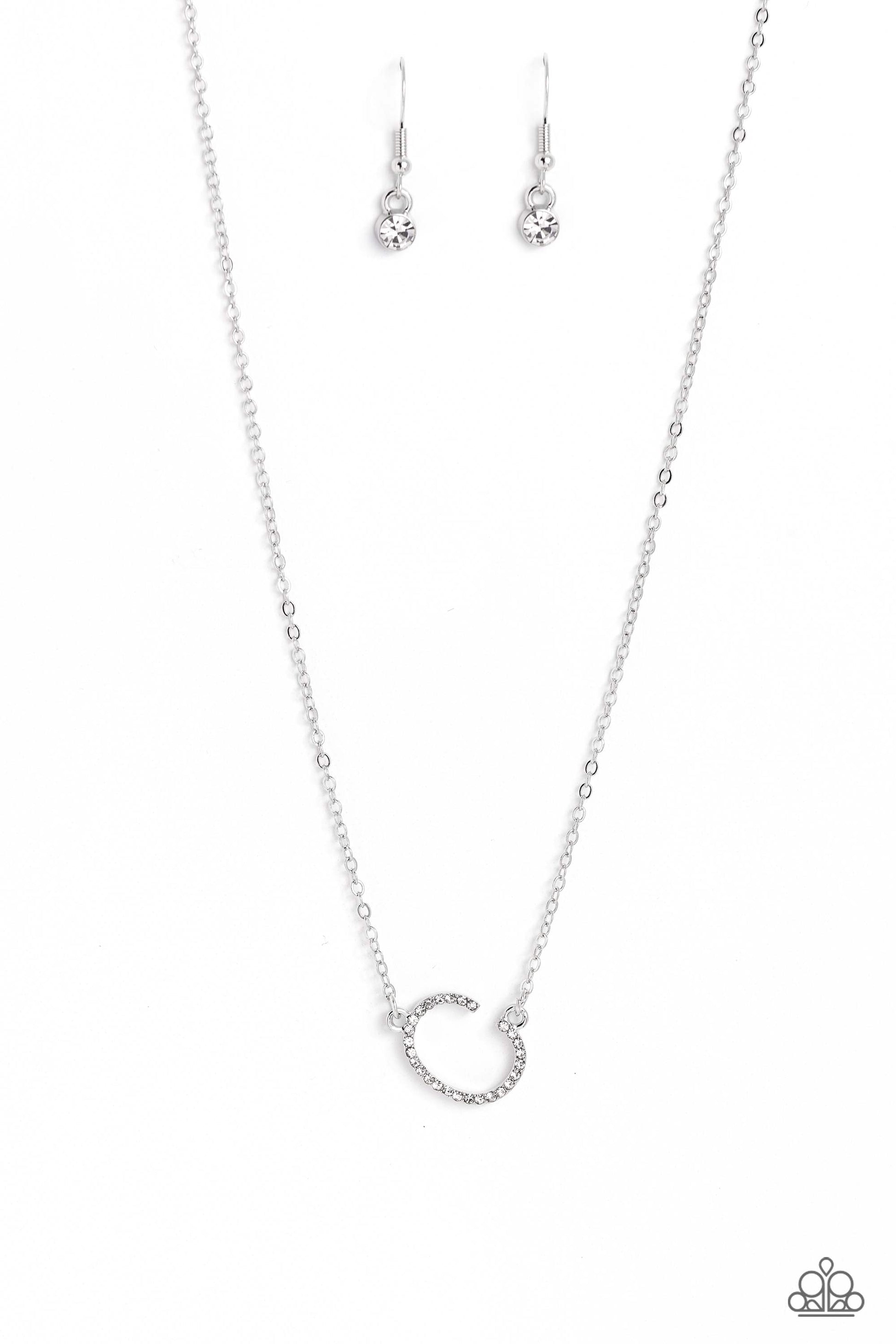 Paparazzi Accessories INITIALLY Yours - C - White Embossed with dainty white rhinestones, a silver letter "C" hovers below the collar from a dainty silver chain, for a sentimentally simple design. Features an adjustable clasp closure. Sold as one individu