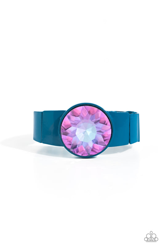Paparazzi Accessories Exaggerated Ego - Blue Featuring a UV shimmer, an exaggerated purple gem is pressed into a metallic blue fitting along bold rectangular frames around the wrist on stretchy bands for a colorful summer look. Sold as one individual brac