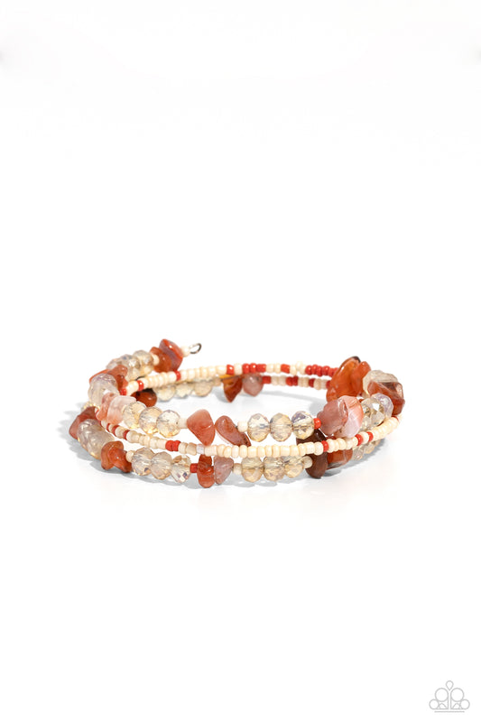 Paparazzi Accessories Notoriously Nuanced - Orange Threaded along a coiled wire, a fashionable collection of Tender Peach, ivory, and Burnt Sienna seed beads and glassy champagne beads combine with chiseled Burnt Sienna natural stones as they coalesce aro