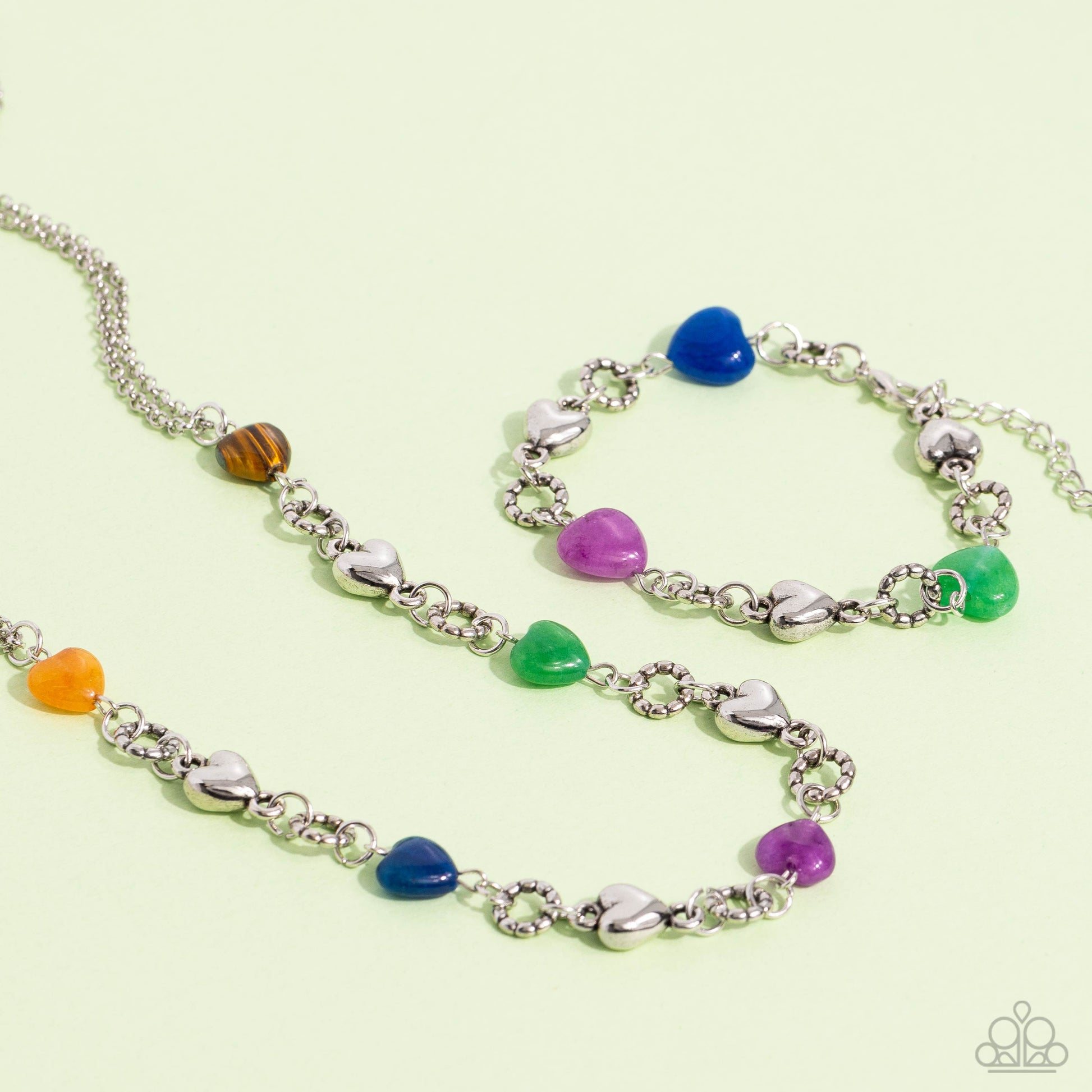 Paparazzi Accessories I Can Feel Your Heartbeat - Multi Heart-shaped lapis, jade, amethyst, and sleek silver hearts alternate along the wrist. Bubbly textured silver rings separate each heart shape infusing the romantically earthy design with a touch of h