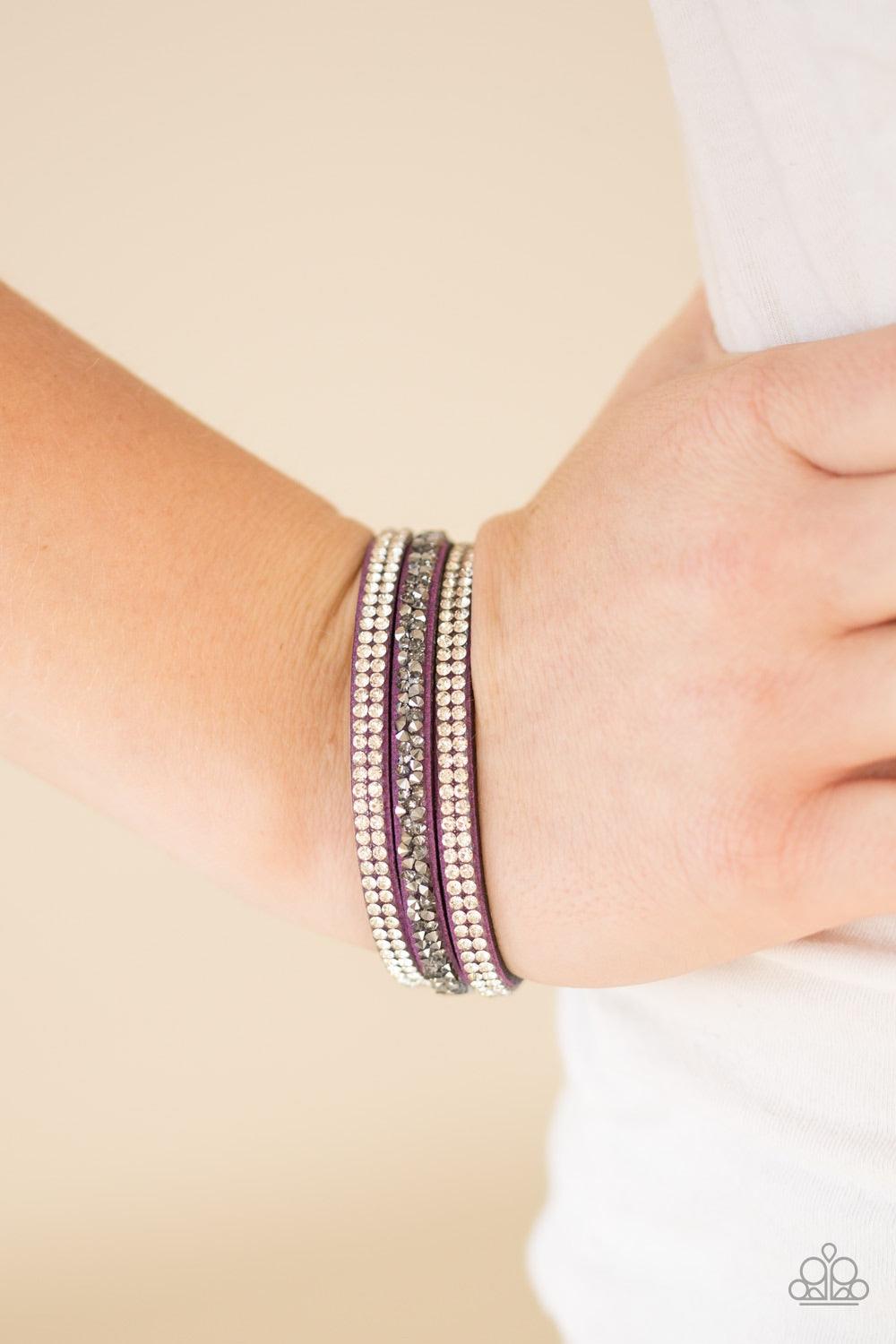 Paparazzi Accessories Mega Glam - Purple Glittery white, smoky, and glassy hematite rhinestones are sprinkled along three strands of refreshing purple suede for a glamorous look. Features an adjustable snap closure. Jewelry