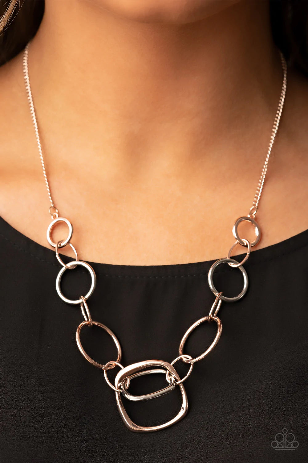 Paparazzi Accessories Linked Up Luminosity - Multi A mismatched collection of rose gold rings and asymmetrical silver hoops delicately links below the collar, resulting in a modern industrial display. Features an adjustable clasp closure. Sold as one indi