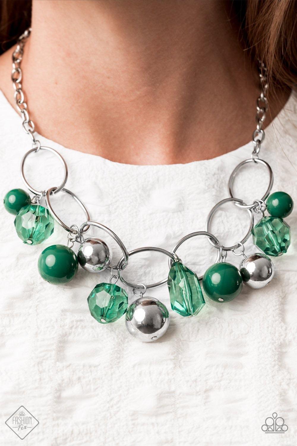 Paparazzi Accessories Cosmic Getaway - Green Infused with faceted Ultramarine Green crystal-like beads, a bubbly collection of oversized silver and Ultramarine Green beads swing from the bottom of an interconnected row of bold silver oval frames, creating