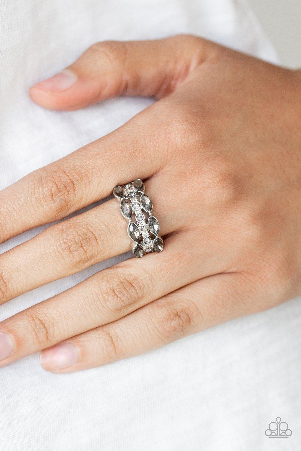 Paparazzi Accessories Distracting Demure - White Two rows of smoky marquise style rhinestones flank one row of dainty smoky rhinestones, coalescing into a timelessly layered piece. Features a dainty stretchy band for a flexible fit. Sold as one individual