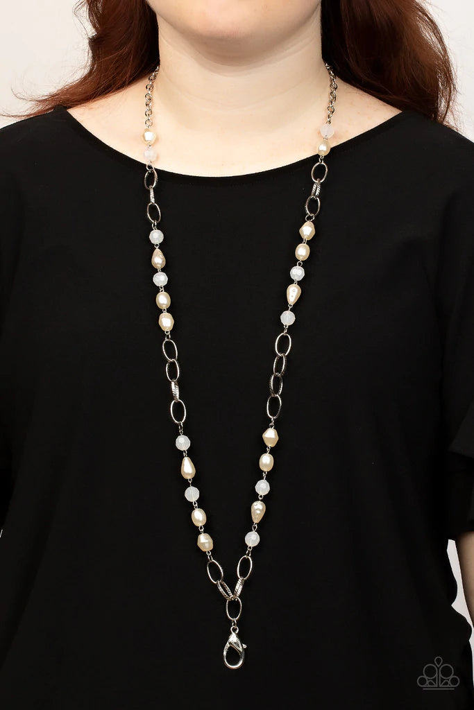 Paparazzi Accessories Tea Part Tango - White *Lanyard Featuring imperfect shapes, luscious pearly beads join opaque white faceted beads along sections of chunky silver chain across the chest for a glamorous look. Features an adjustable clasp closure. Sold
