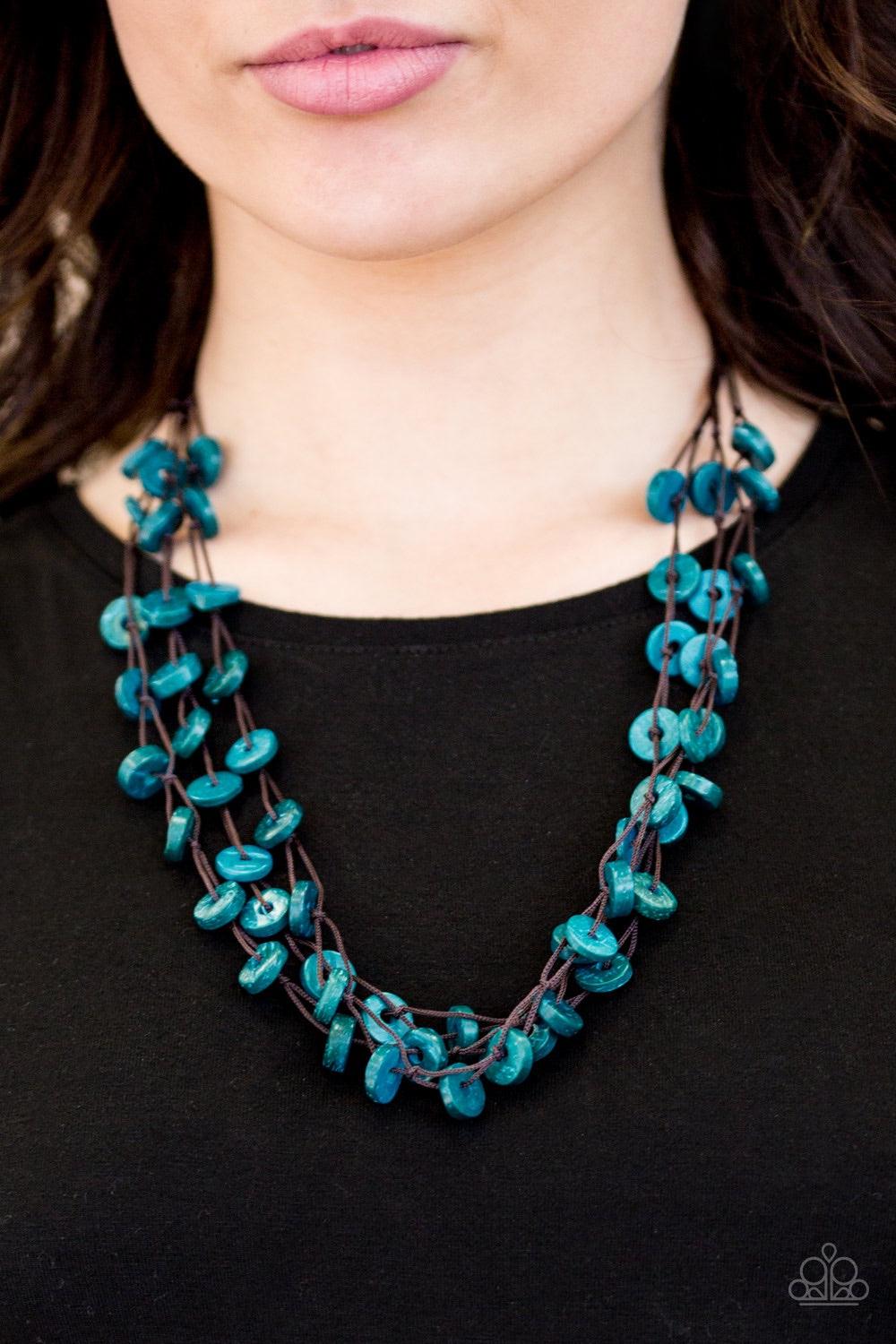 Paparazzi Accessories Hoppin Honolulu - Blue Tinted in a refreshing blue finish, distressed wooden discs trickle along strands of knotted brown cording, creating colorful layers below the collar for a seasonal vibe. Features a button-loop closure. Jewelry