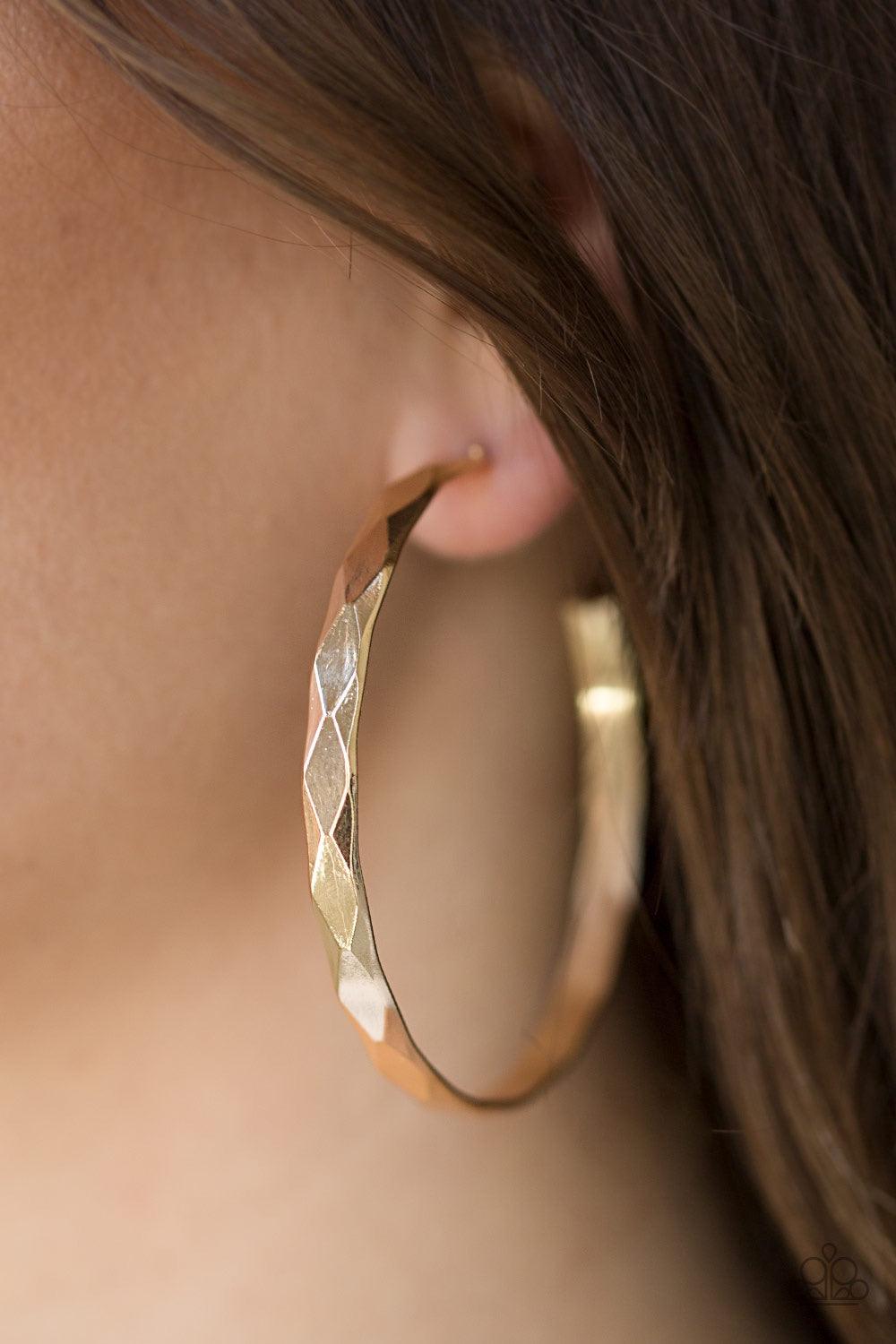 Paparazzi Accessories Hey, HAUTE Stuff - Gold Featuring edgy diamond-cut texture, a glistening gold hoop curls around the ear in a bold industrial fashion. Earring attaches to a standard post fitting. Hoop measures 2 1/4” in diameter. Jewelry