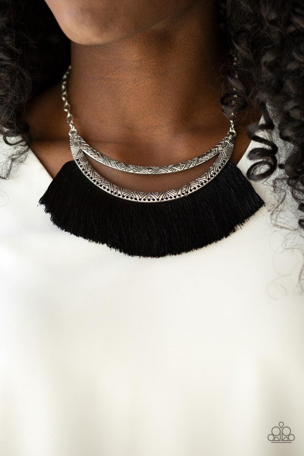 Paparazzi Accessories The MANE Event - Black A plume of shiny black thread flares out from the bottom of an airy half-moon frame stamped in tribal inspired patterns, creating a bold fringe below the collar. Features an adjustable clasp closure. Jewelry