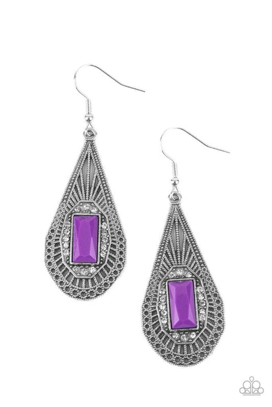 Paparazzi Accessories Deco Dreaming - Purple A bright purple baguette-cut bead, bordered with sparkling white rhinestones, sits center stage inside a teardrop frame. Delicate art deco filigree fills the frame creating a richly embellished lure. Earring at