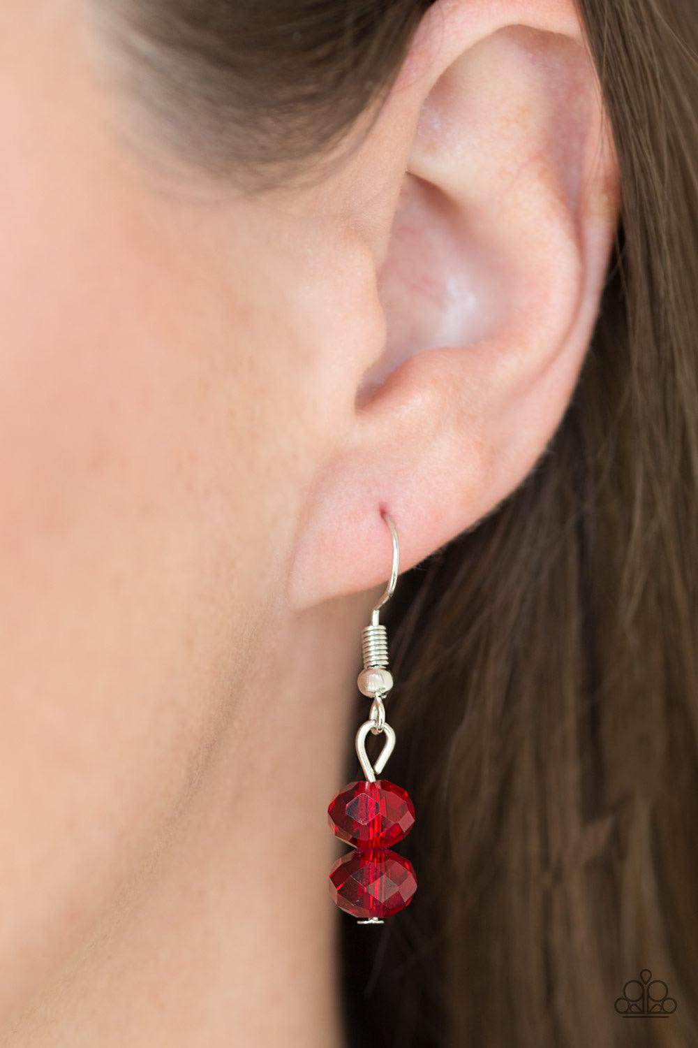 Paparazzi Accessories High Standards - Red Infused with rows of shimmery silver chains, a strand of glittery red crystal-like beads and classic silver accents drape across the chest for a regal finish. Features an adjustable clasp closure. Sold as one ind