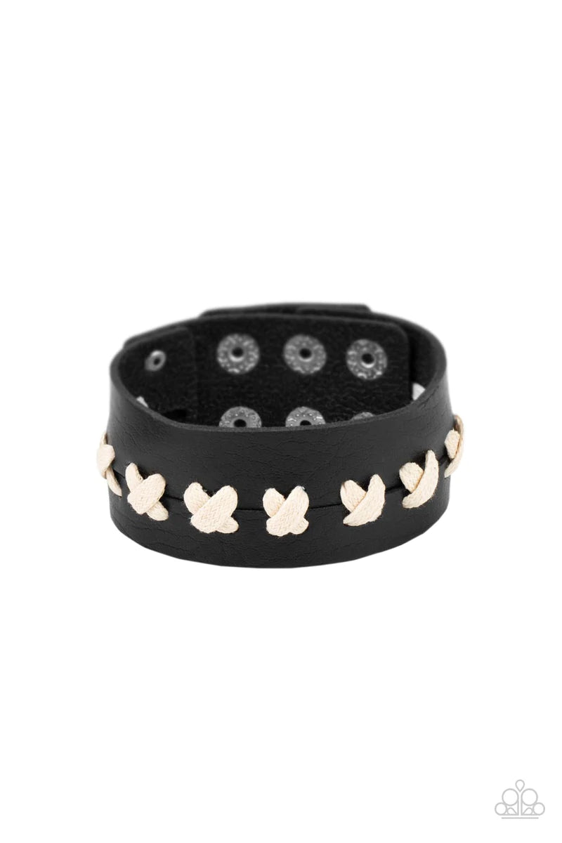 Paparazzi Accessories Metro Mustang - Black White laces are threaded through two pieces of black leather, creating crisscrossed stitches that hold the rustically studded centerpiece together. Features an adjustable snap closure. Sold as one individual bra