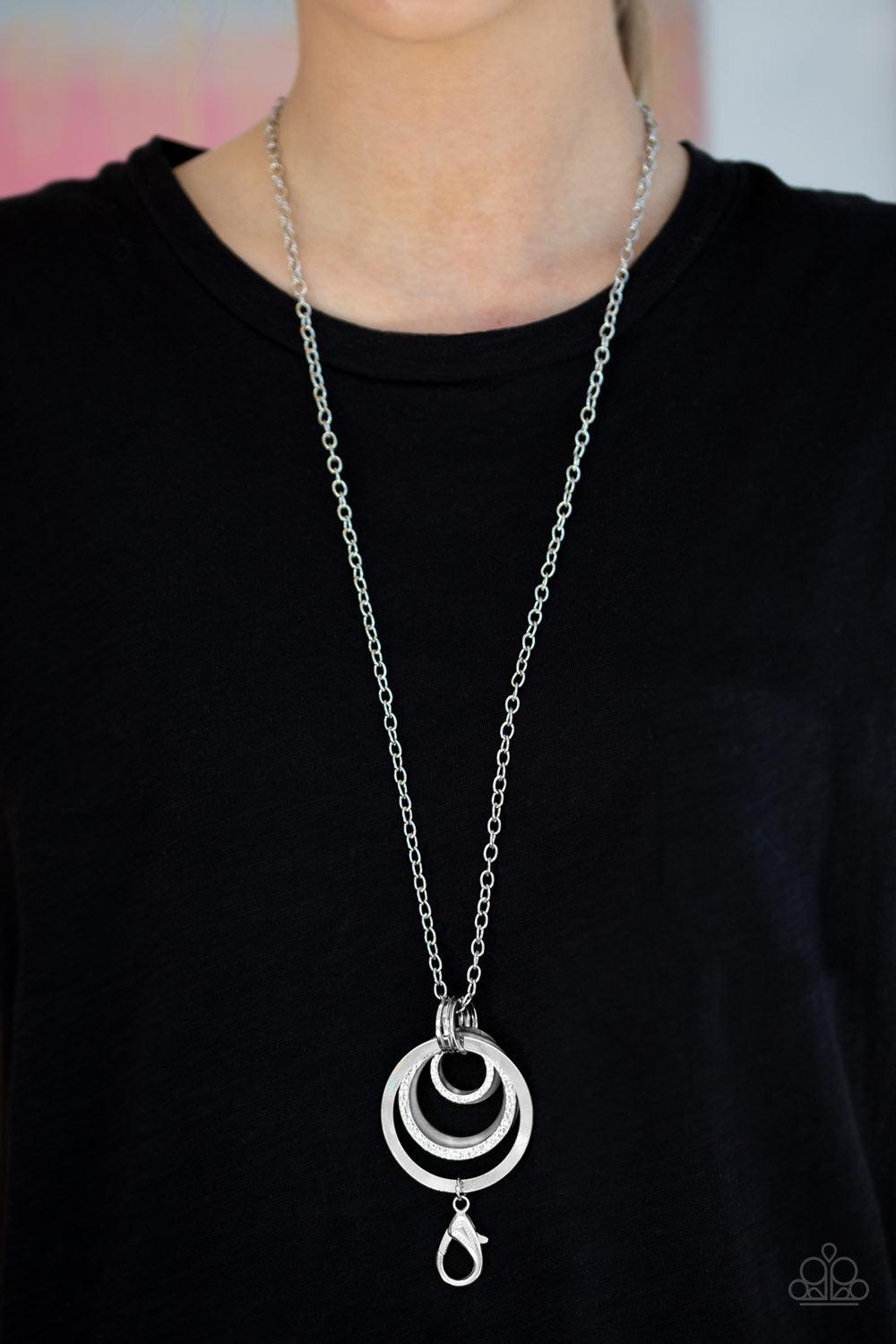 Paparazzi Accessories Coast Coasting - Silver Brushed in an iridescent finish, shell-like hoops join mismatched silver hoops at the bottom of an elongated silver chain for a whimsical look. A lobster clasp hangs from the bottom of the design to allow a na