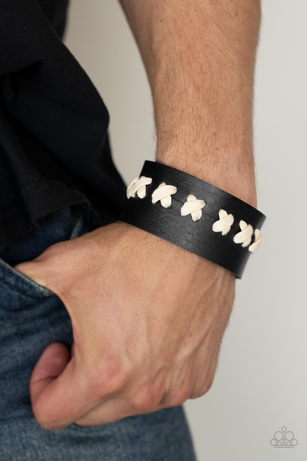 Paparazzi Accessories Metro Mustang - Black White laces are threaded through two pieces of black leather, creating crisscrossed stitches that hold the rustically studded centerpiece together. Features an adjustable snap closure. Sold as one individual bra
