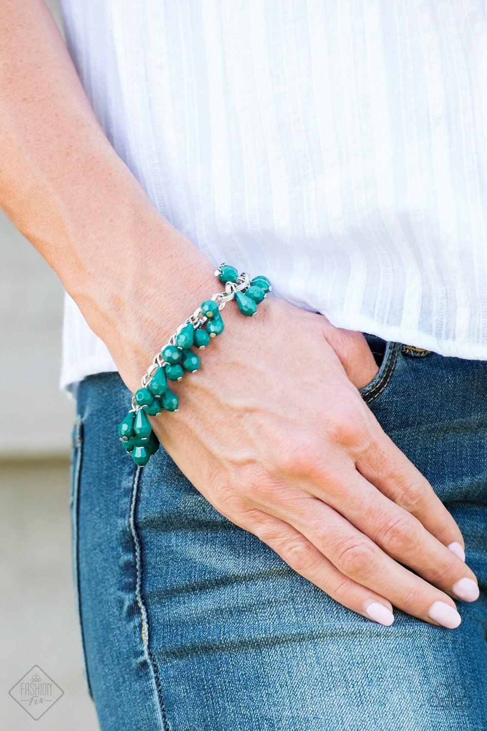 Paparazzi Accessories Malibu Masquerade - Green Featuring round and teardrop shapes, clusters of faceted Quetzal Green beads swing from a shimmery silver chain, creating a playful fringe around the wrist. Features an adjustable clasp closure. Jewelry