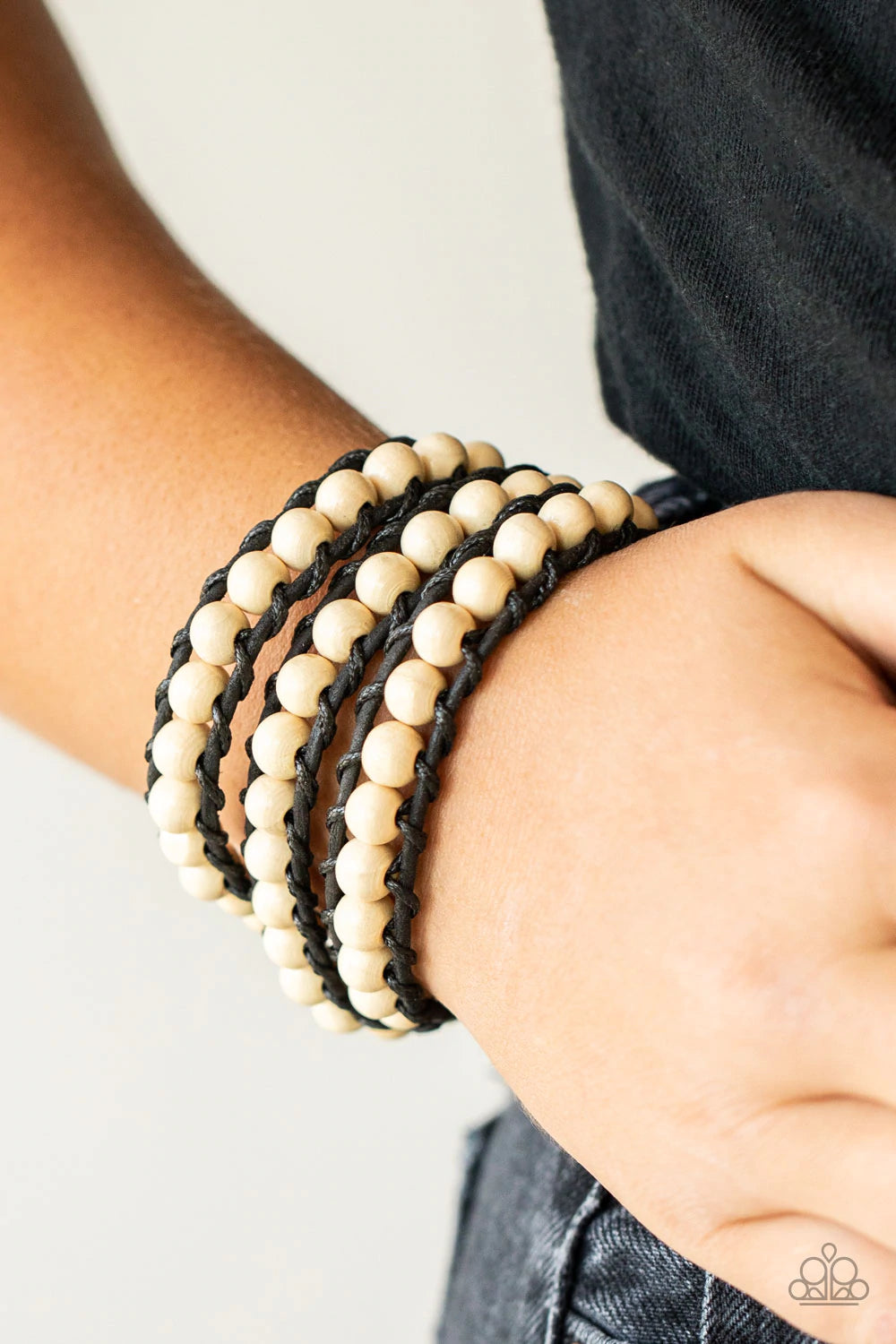 Paparazzi Accessories Pine Paradise - White A row of white wooden beads are knotted in place along two black leather cords, creating multiple earthy layers around the wrist with its extended length. Features an adjustable button loop closure. Sold as one
