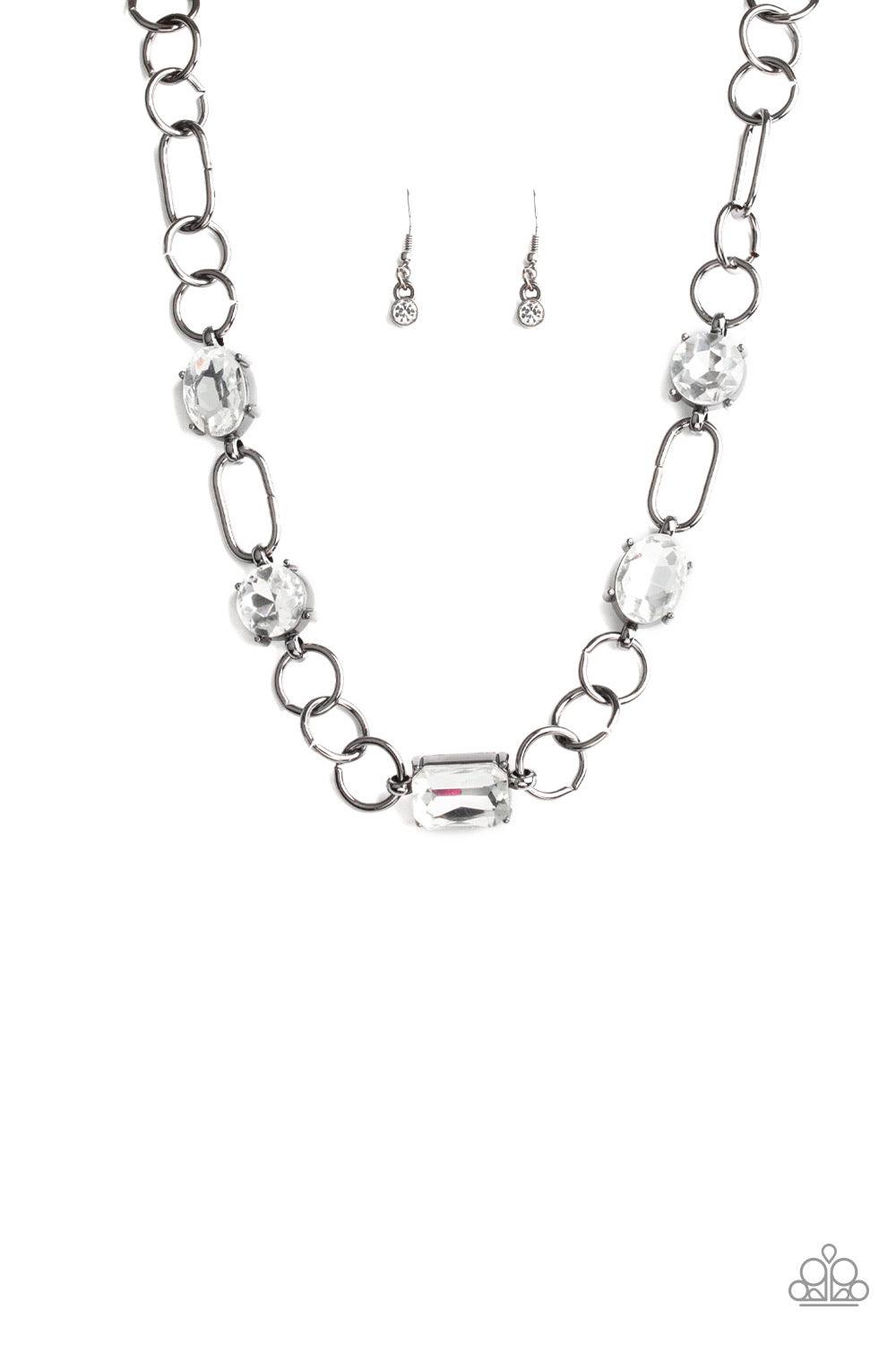 Paparazzi Accessories Urban District - Black Featuring round, oval, and emerald style cuts, glittery white rhinestone fittings link with mismatched gunmetal rings below the collar for an edgy glamorous look. Features an adjustable clasp closure. Necklaces