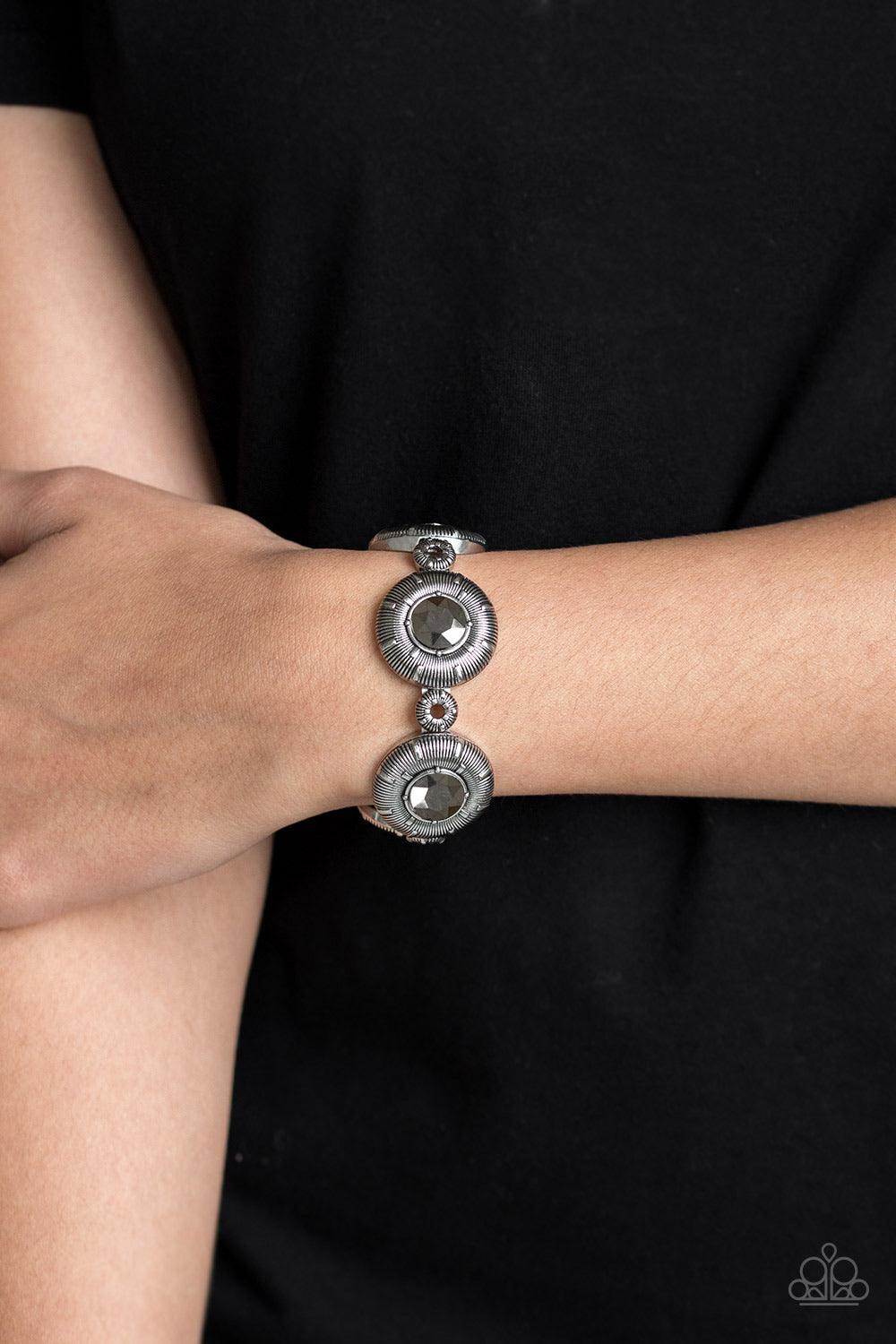 Paparazzi Accessories Original Opulence - Silver Radiating with glittery hematite rhinestone centers, dramatic silver frames and dainty silver beads are threaded along a stretchy band for an edgy style. Jewelry