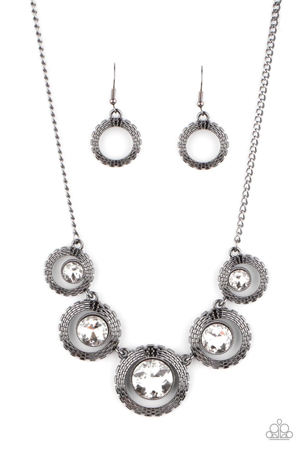 Paparazzi Accessories PIXEL Perfect - Black Graduating in size, a series of glittery white rhinestones are asymmetrical nestled inside glistening gunmetal frames featuring box chain-like texture. The edgy display delicately links below the collar, creatin