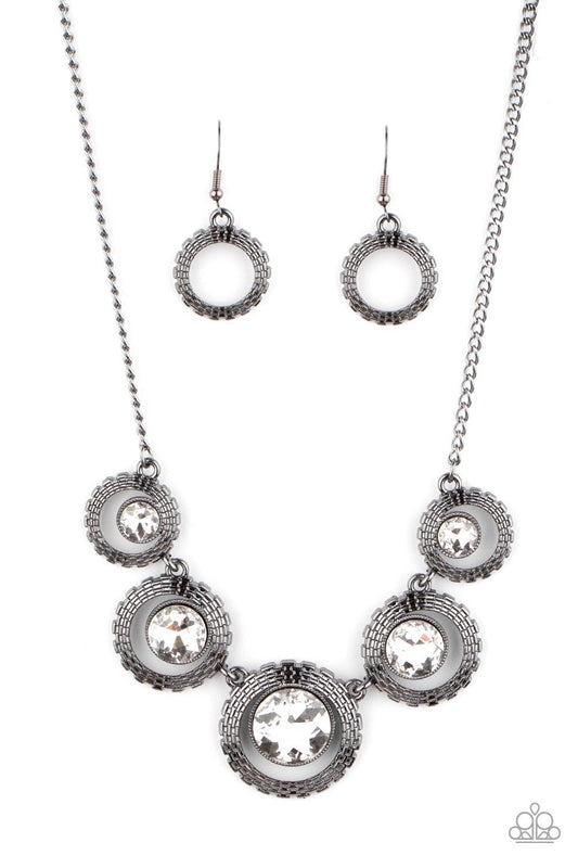Paparazzi Accessories PIXEL Perfect - Black Graduating in size, a series of glittery white rhinestones are asymmetrical nestled inside glistening gunmetal frames featuring box chain-like texture. The edgy display delicately links below the collar, creatin