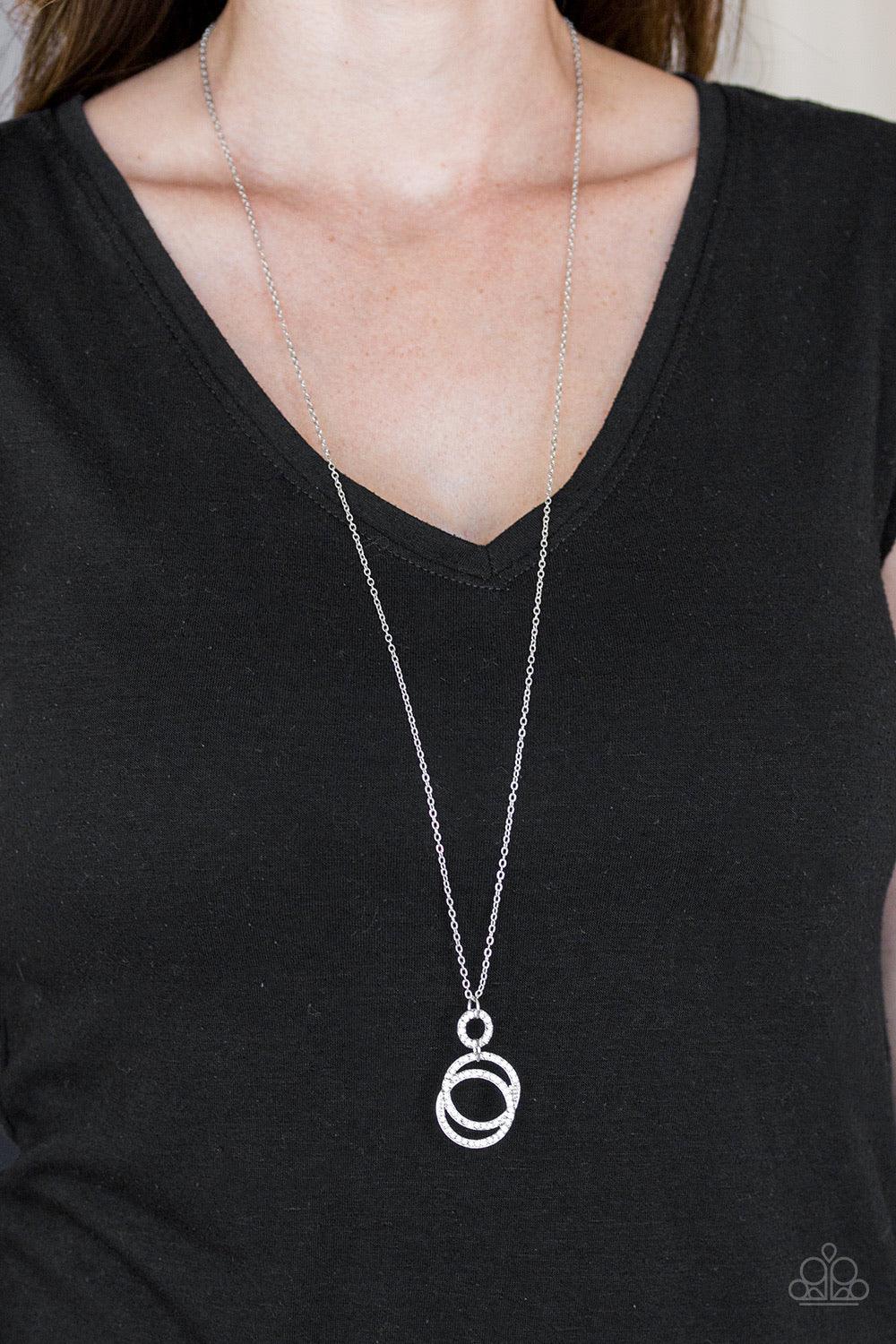 Paparazzi Accessories Timeless Trio - White Encrusted in radiant white rhinestones, three silver hoops interlock at the bottom of an elongated silver chain for an elegant look. Features an adjustable clasp closure. Sold as one individual necklace. Include