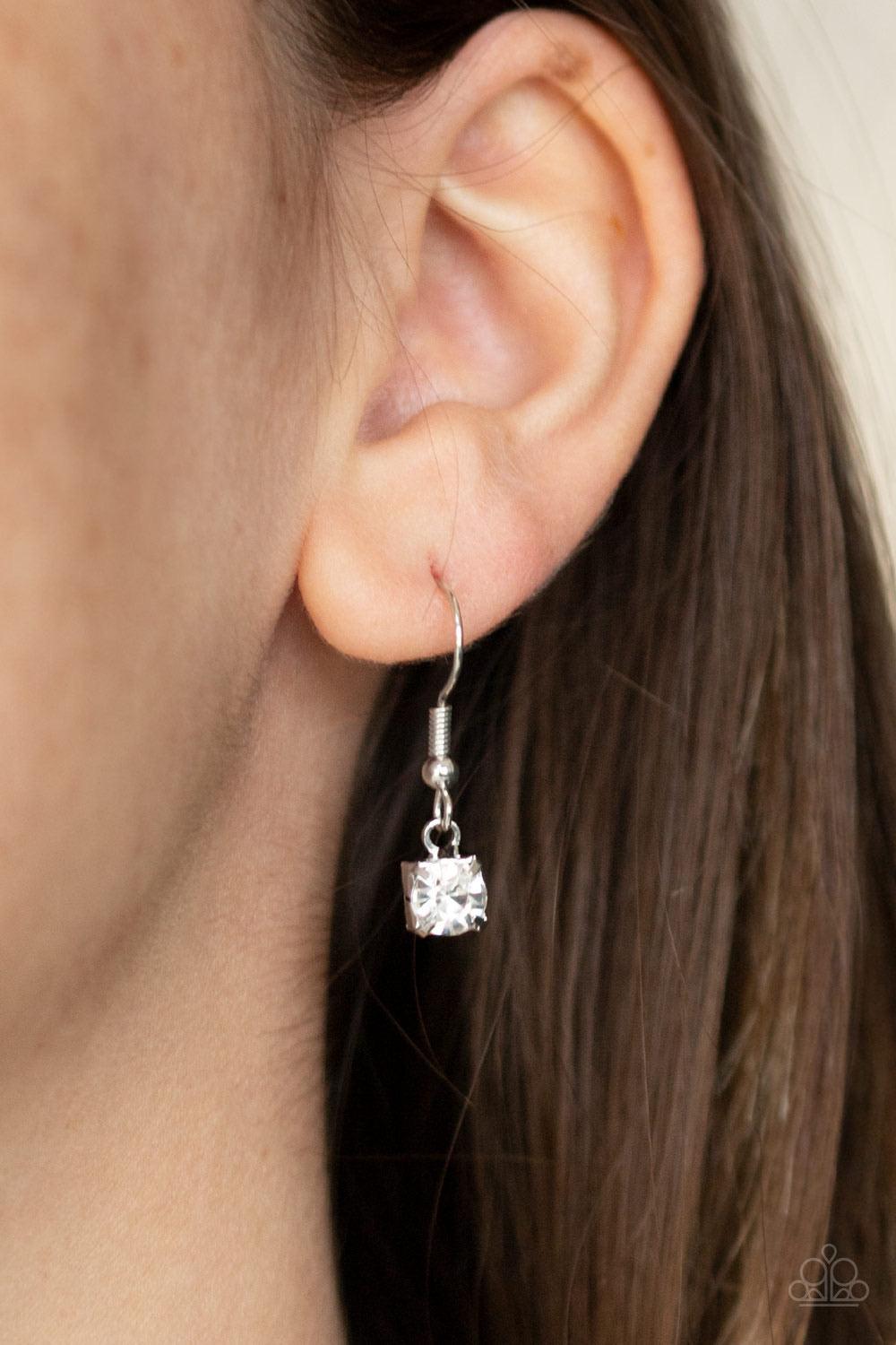 Paparazzi Accessories Inner STARLIGHT - White Featuring square silver fittings, a dainty strand of glassy white rhinestones drapes around the neck. The glittery strands delicately connect, splitting off into two twinkling tassels down the chest. Features