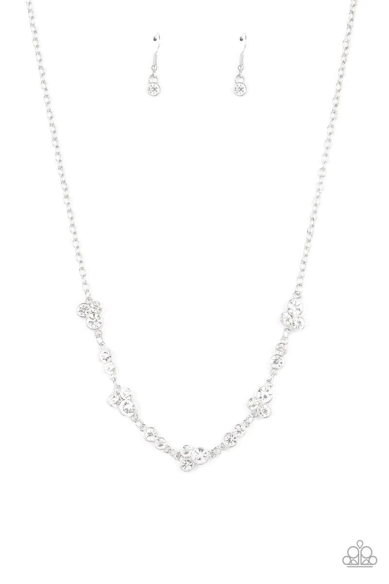 Paparazzi Accessories Gorgeously Glistening - White Encased in sleek silver frames, dainty pairs and trios of glittery white rhinestones delicately link into a timeless display below the collar. Features an adjustable clasp closure. Sold as one individual