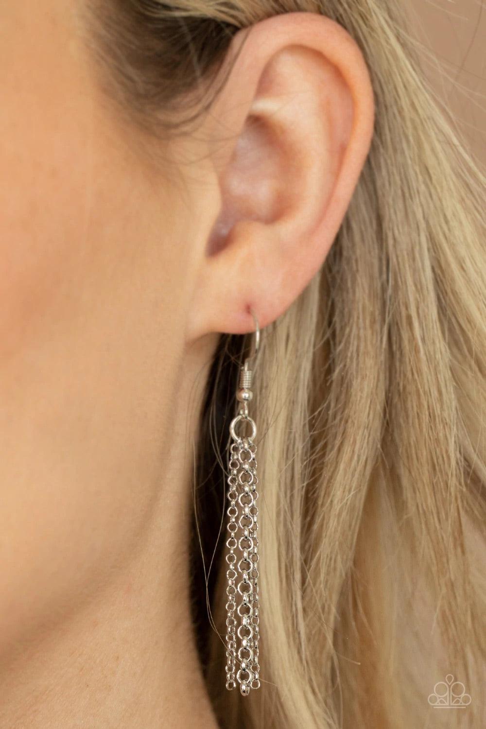 Paparazzi Accessories Palm Promenade - Silver Infused with silver beaded accents, a lifelike silver palm leaf frame attaches to the bottom of a shimmery silver chain. A silver chain tassel swings from the bottom, adding flirtatious movement to the summery