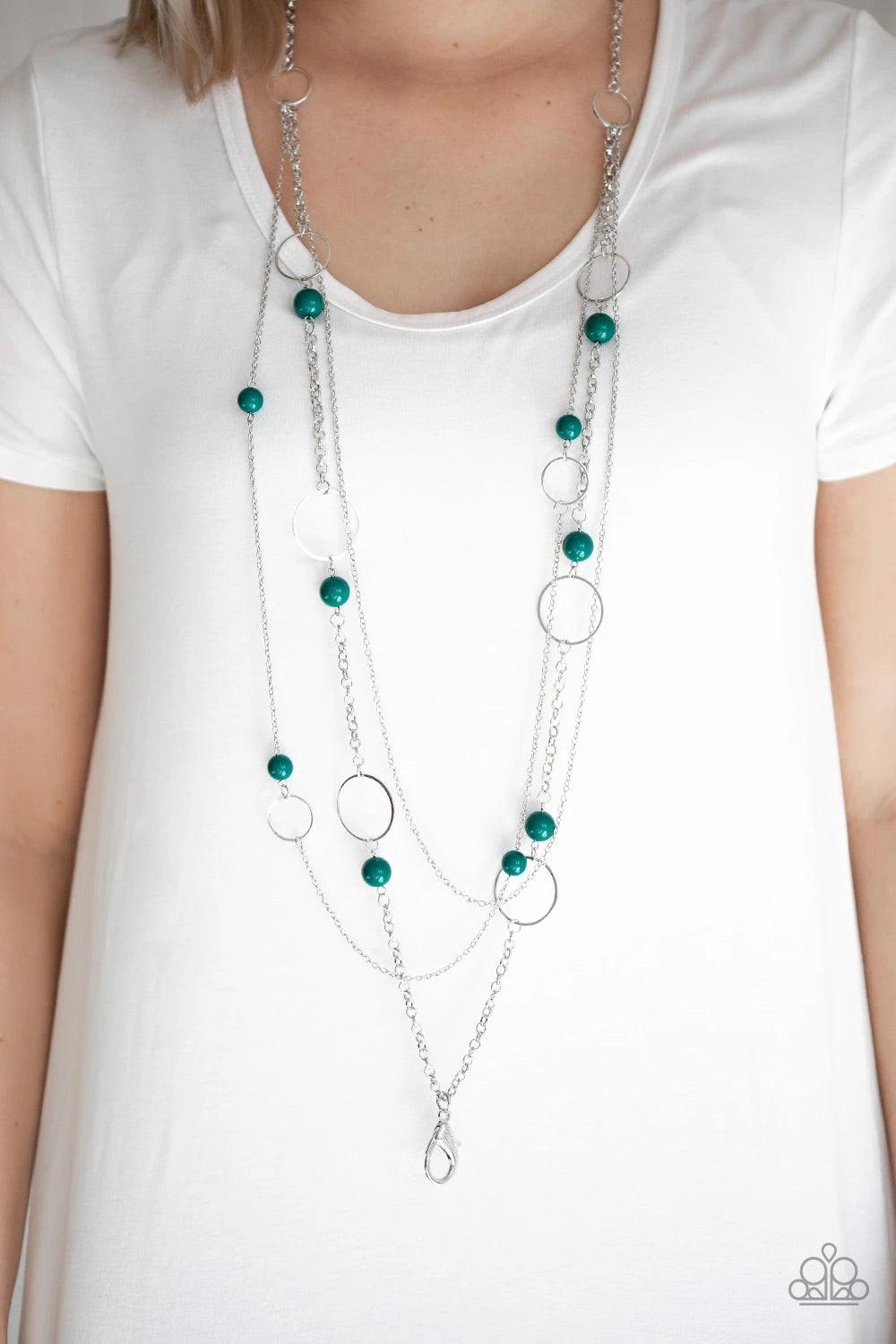 Paparazzi Accessories Beachside Babe - Green *Lanyard Featuring refreshing green beads and shimmery silver hoops, mismatched silver chains layer down the chest for a seasonal look. A lobster clasp hangs from the bottom of the design to allow a name badge