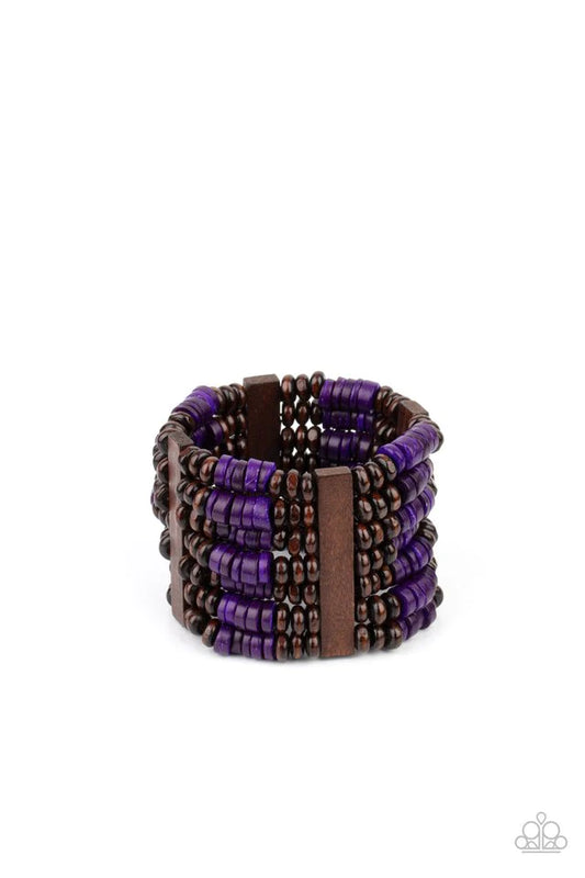 Paparazzi Accessories Vacay Vogue - Purple Held together by rectangular wooden frames, rows of brown wooden and distressed purple discs are threaded along stretchy bands around the wrist for a seasonal pop of color around the wrist. Sold as one individual