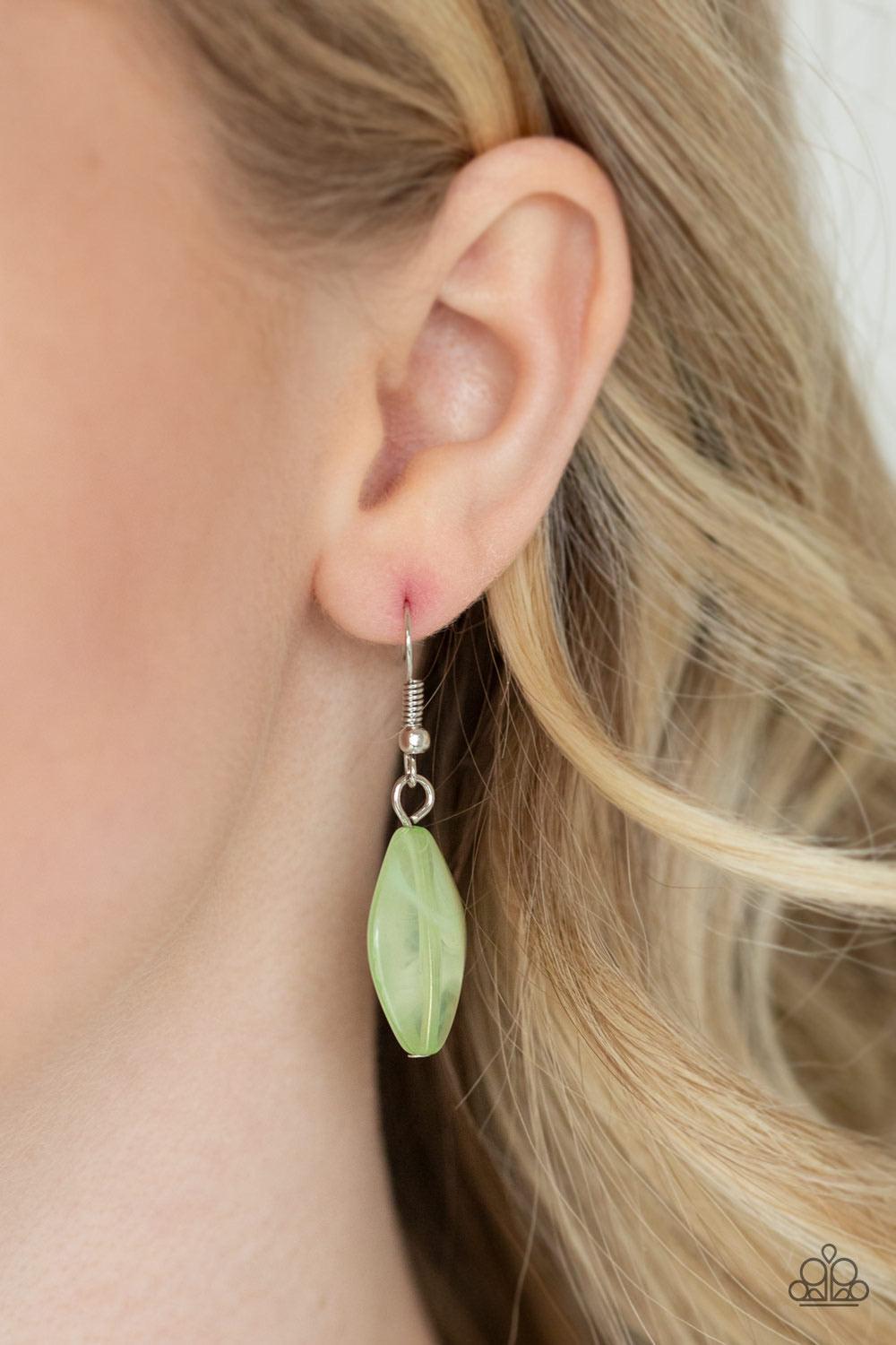 Paparazzi Accessories Sky High Style - Green Infused with shimmery silver chains, a collection of earthy brown beads, cloudy green beads, and glistening silver feather charms swing from the bottom of a bold silver hoop. The whimsical tassel attaches to a
