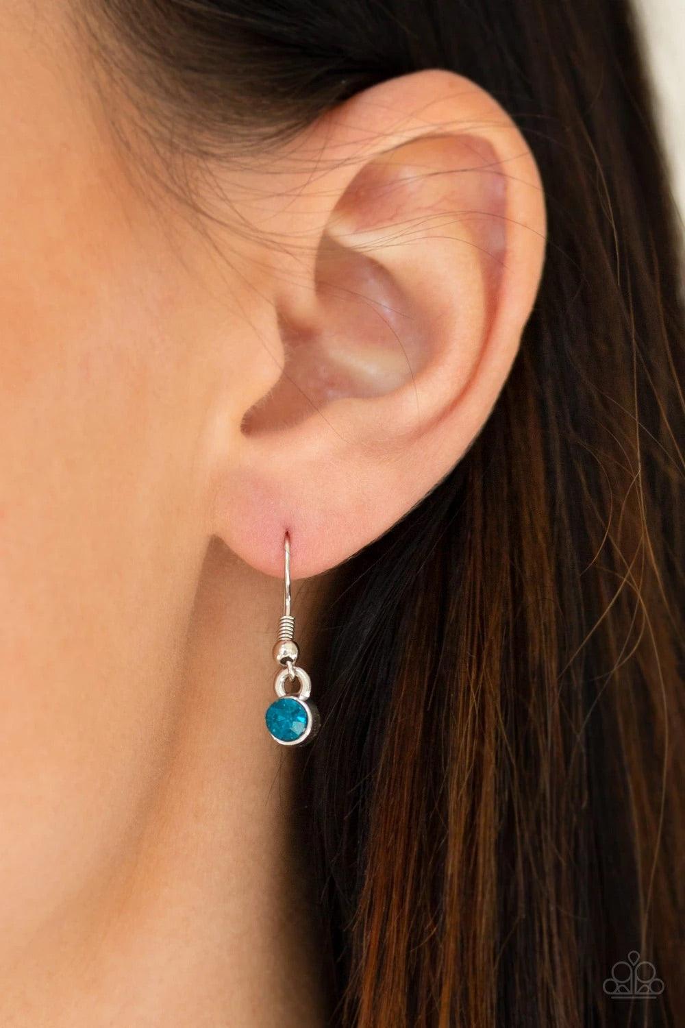 Paparazzi Accessories Walk On The WILDFLOWER Side - Blue Filigree filled petals flare from a glittery blue rhinestone center, creating a whimsical floral pendant at the bottom of a lengthened silver chain. Features an adjustable clasp closure. Sold as one
