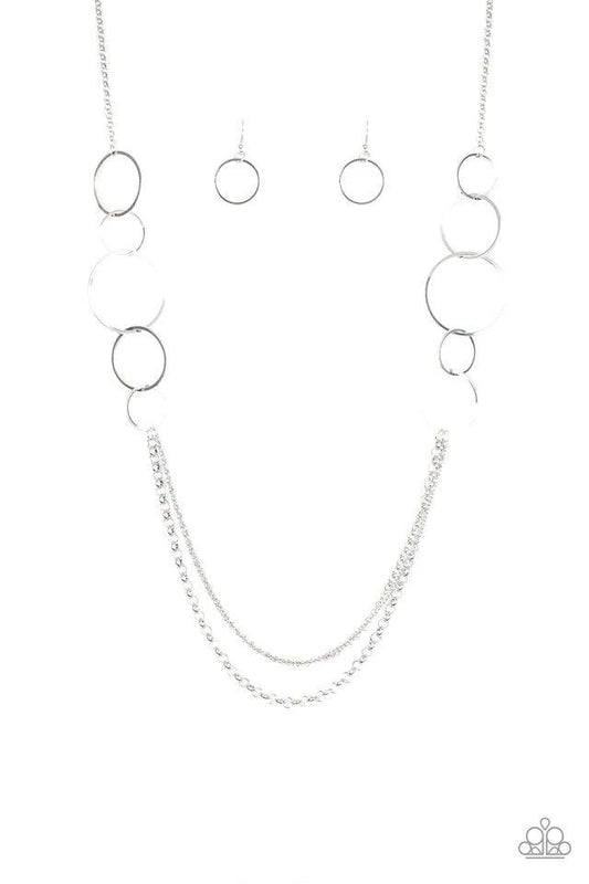 Paparazzi Accessories Ring In The Radiance - Silver A collection of interlocking silver rings give way to layers of mismatched silver chains down the chest, creating a stunning tone-on-tone statement piece. Features an adjustable clasp closure. Sold as on