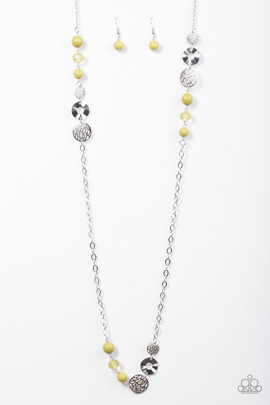 Paparazzi Accessories Midnight Musical - Green Stenciled and hammered silver accents trickle along a shimmery silver chain. Crystal-like and polished green beading join the metallic accents, adding a neutral pop of color to the whimsical palette. Features