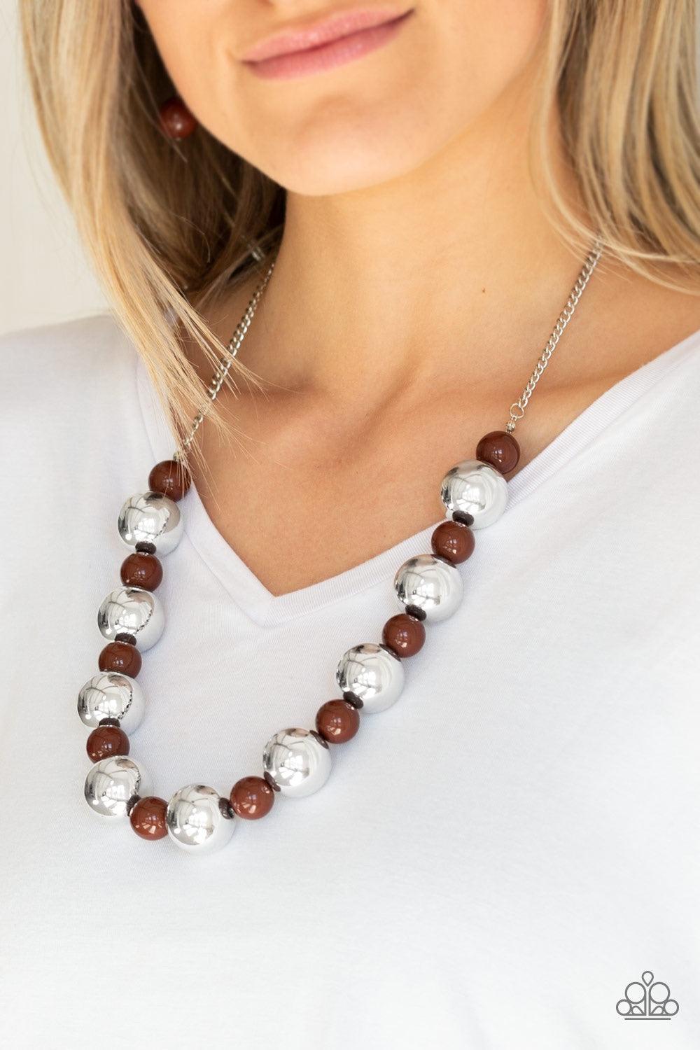 Paparazzi Accessories Top Pop - Brown Polished brown beads and dramatic silver beads drape below the collar for a perfect pop of color. Features an adjustable clasp closure. Jewelry