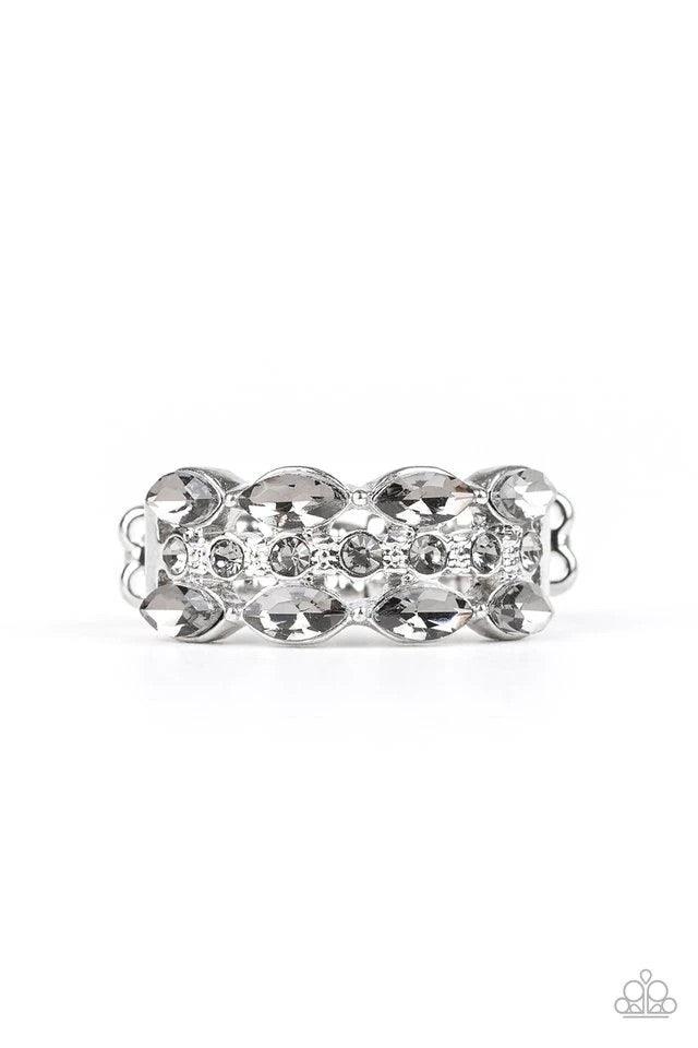Paparazzi Accessories Distracting Demure - White Two rows of smoky marquise style rhinestones flank one row of dainty smoky rhinestones, coalescing into a timelessly layered piece. Features a dainty stretchy band for a flexible fit. Sold as one individual