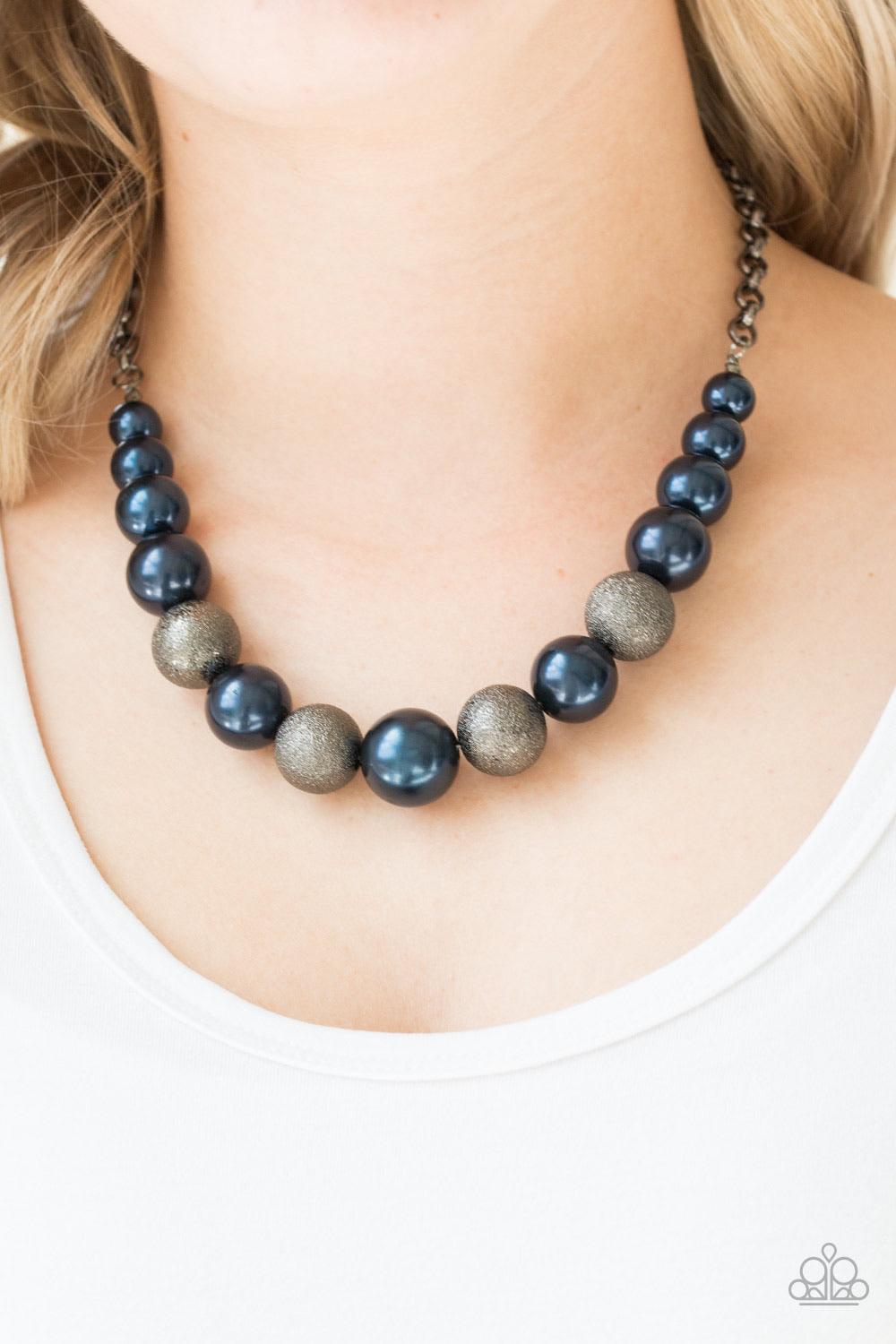 Paparazzi Accessories Color Me CEO - Blue Dusted in glitter, sparkling gunmetal and pearly blue beads are threaded along an invisible wire below the collar for a glamorous look. Features an adjustable clasp closure. Sold as one individual necklace. Includ