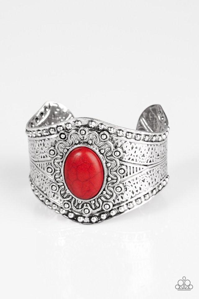Paparazzi Accessories Mojave Majesty - Red Delicately hammered and studded in tribal inspired textures, a thick silver cuff wraps around the wrist in an artisan inspired fashion. A smooth red stone is pressed into the middle of a silver sunburst pattern,