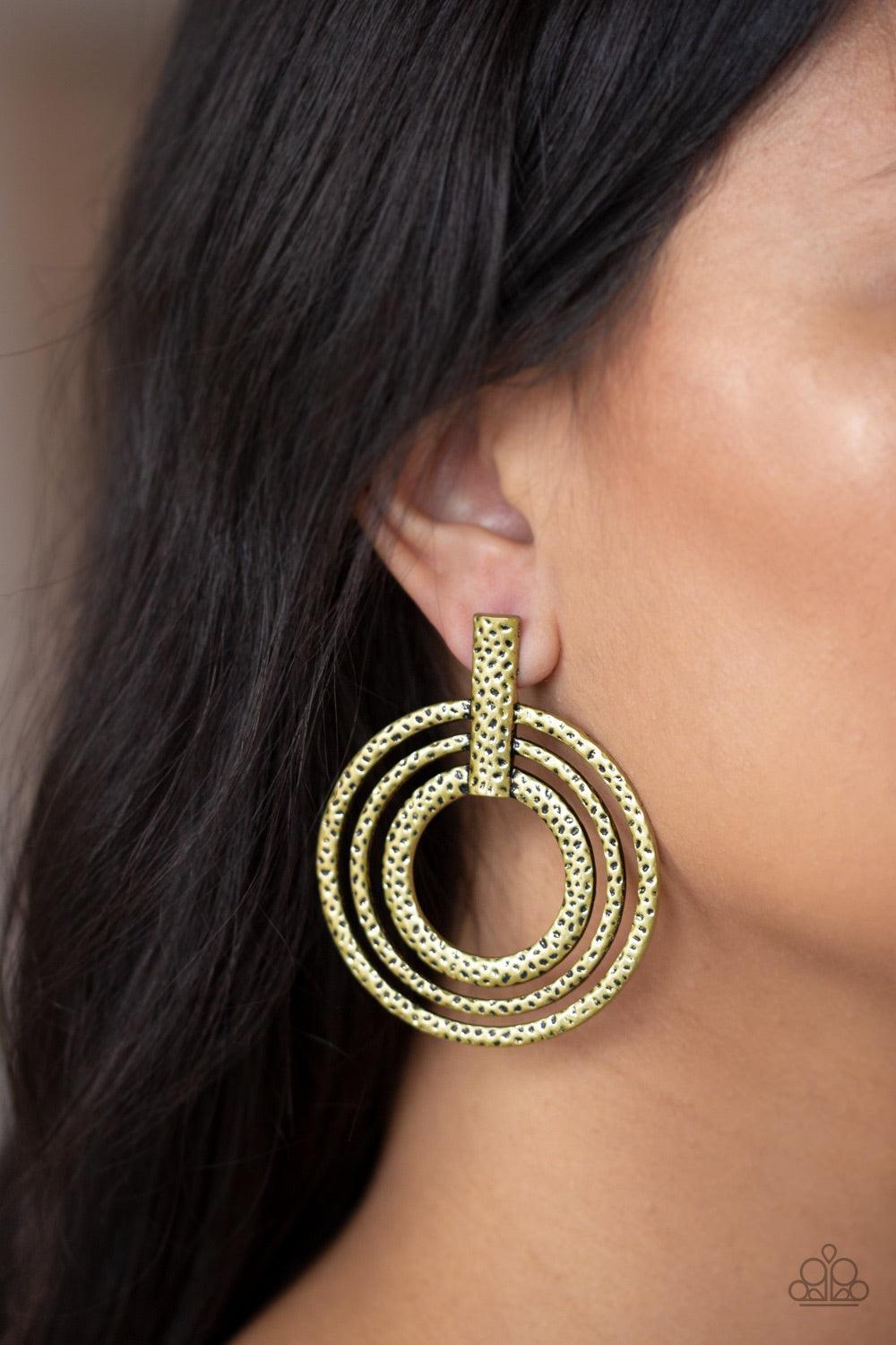 Paparazzi Accessories Ever Elliptical - Brass Delicately hammered in an antiqued shimmer, glistening brass circles attach to a rectangular brass fitting, spiraling into a dizzying frame. Features a standard post fitting. Jewelry