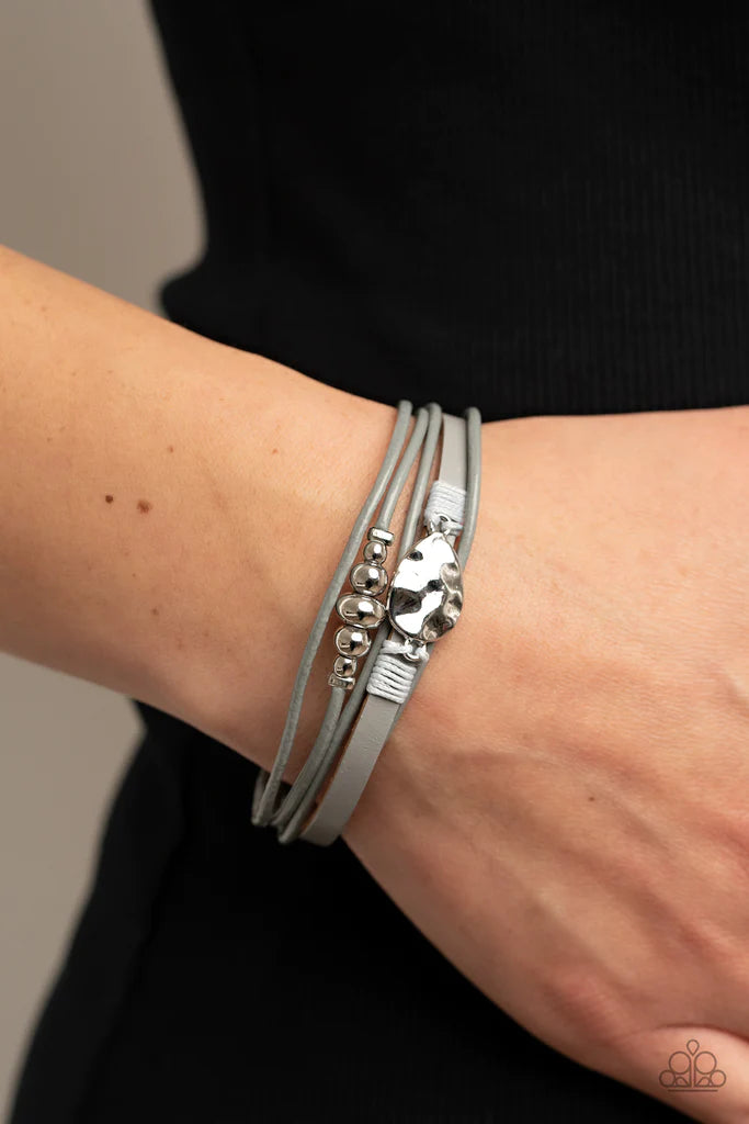 Paparazzi Accessories Tahoe Tourist - Silver Infused with a silver beaded accent, rows of shiny Ultimate Gray cording join an Ultimate Gray leather band around the wrist. A hammered silver teardrop is knotted in place with Ultimate Gray thread, adding an